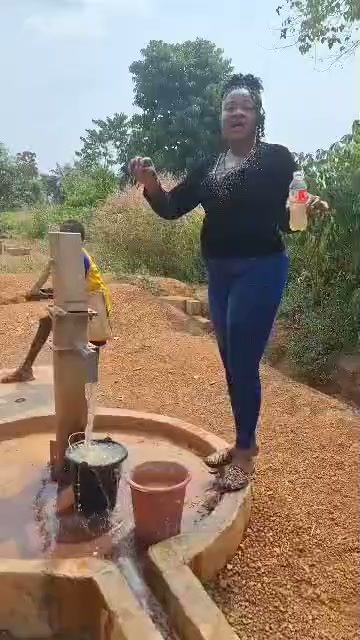 Clean water flowing from a borehole hand pump built for a rural community