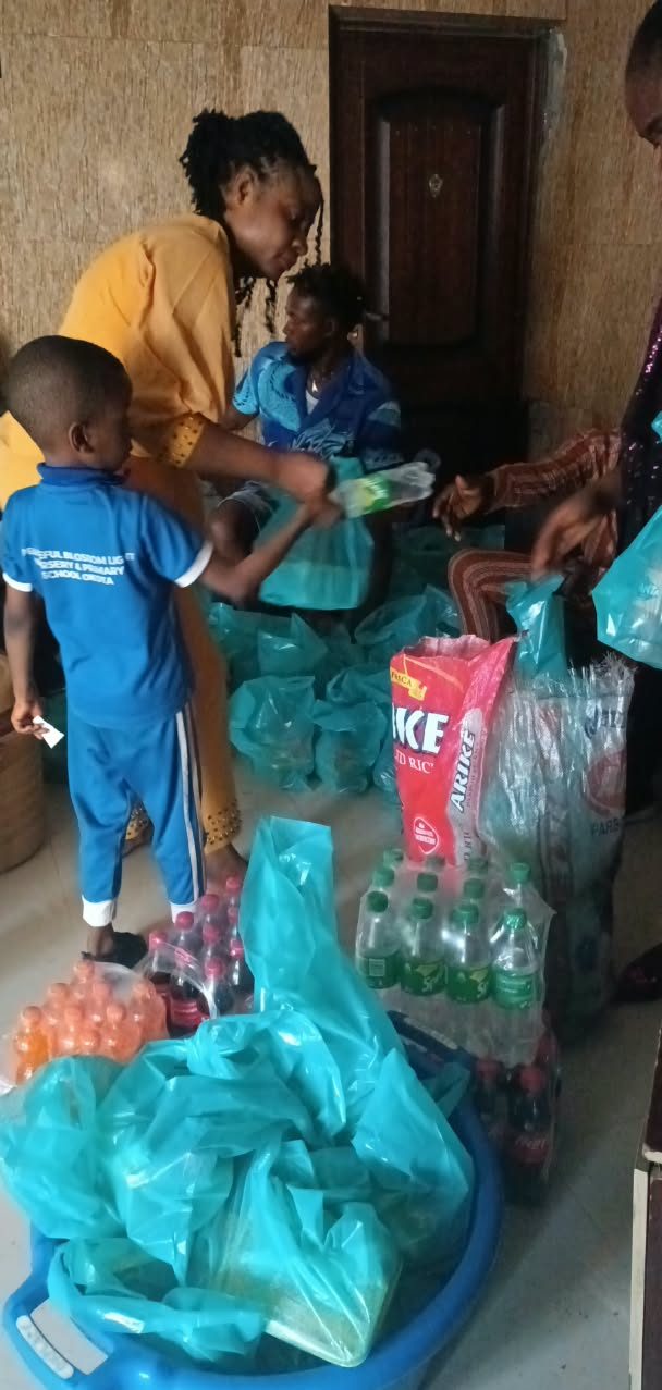 A boy in his school uniform receiving a bag of food supplies from the foundation