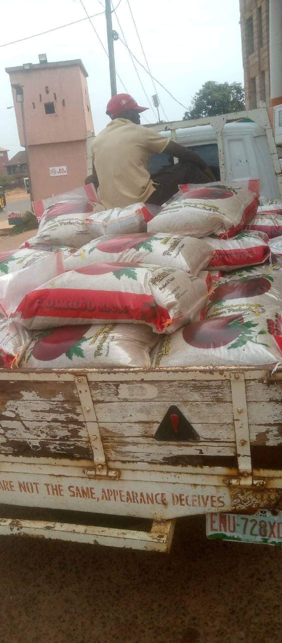 A truck loaded with bags of rice arriving for a Helping Hands food distribution
