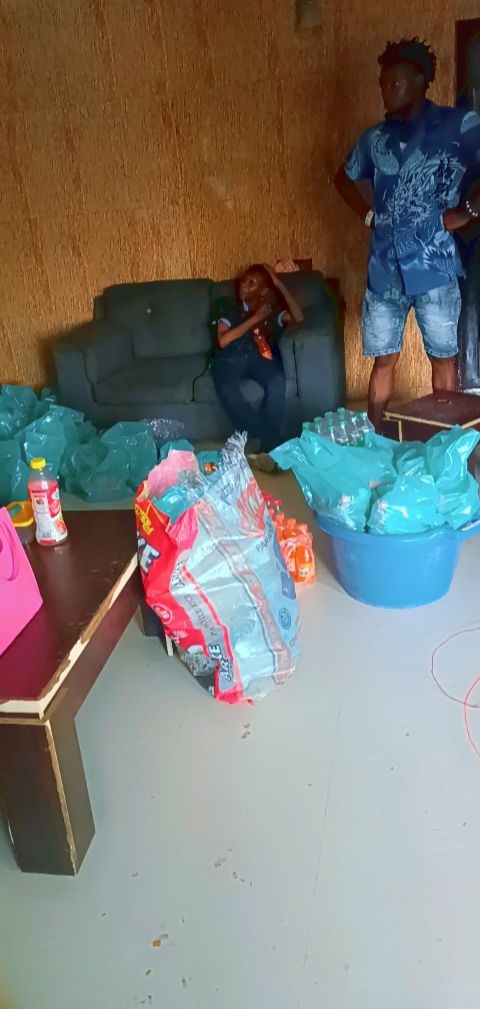 Provisions, rice and crates of drinks staged indoors before loading out