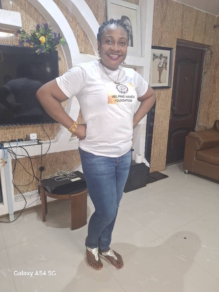 Nurse Vivian Okafor wearing the branded Ogochukwu Helping Hands Foundation shirt